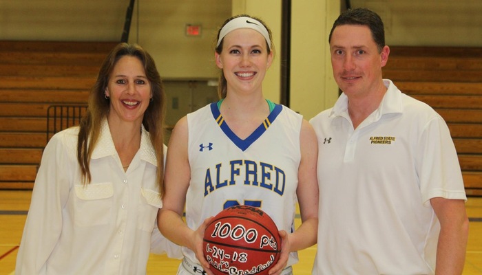 Catherine Bialecki presented with a commemorative ball for reaching the 1,000 point milestone
