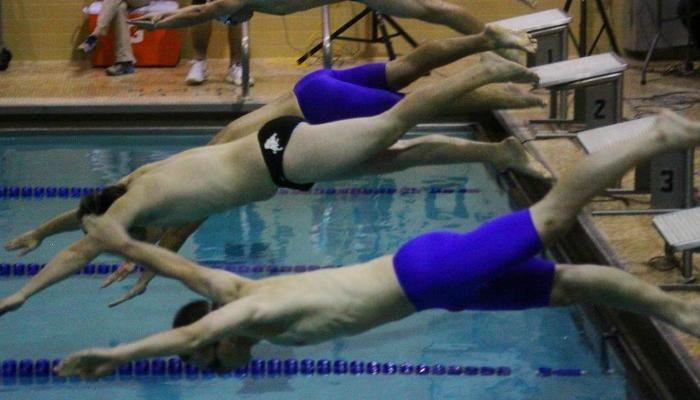Swimmers Split Tri-Meet at Wells