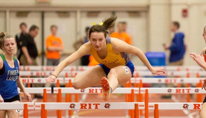 Emily Brigman goes over a hurdle