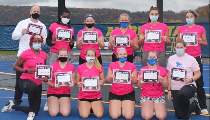 Members of the Volleyball team show who they "Stand For" to honor those that fight and have fought Breast Cancer.